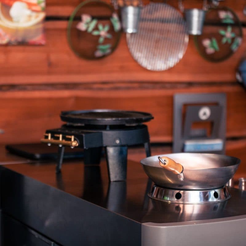 A stainless steel skillet heating on a gas burner. Illustrative stock photograph, not a photograph of the reviewed pan.